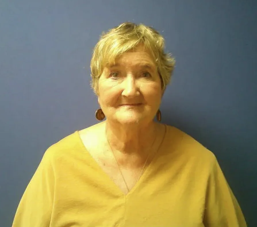 Photo of Diane Lambert released by the N.C. State Bureau of Investigation. She has short blond hair and wears a yellow top, in front of a blue wall.