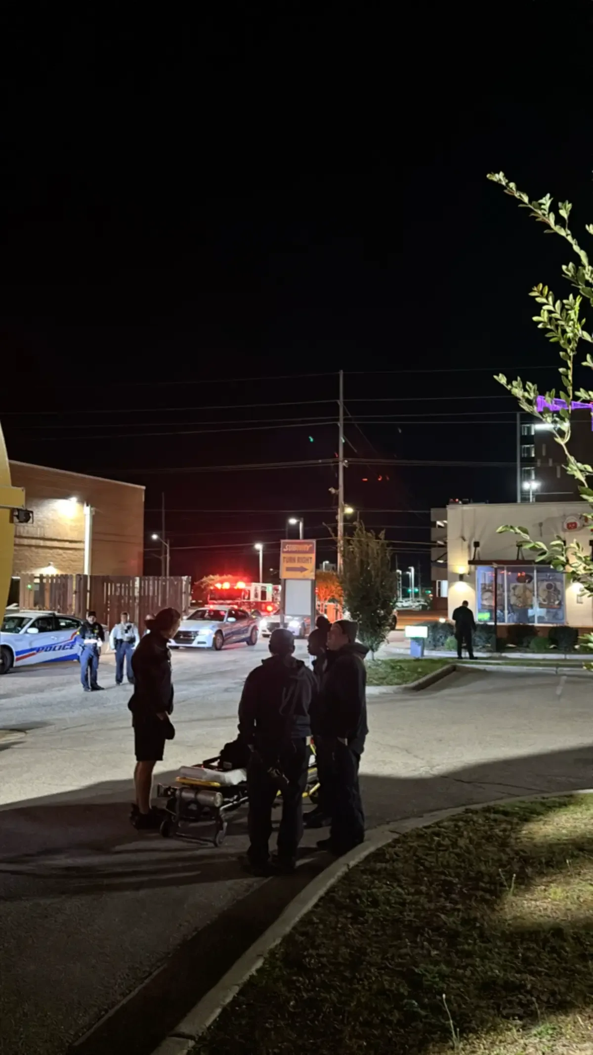 Police cars, an ambulance and responders near a restaurant on Owen Drive in Fayetteville at night.